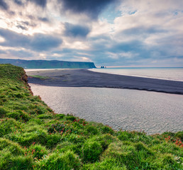 Dramatic summer view of Kirkjufjara beach. Splendid outdoor scene of Reynisdrangar cliffs from...