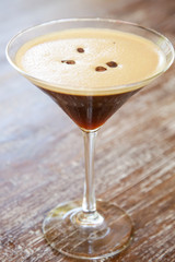 Espresso martini cocktail served on the wooden table