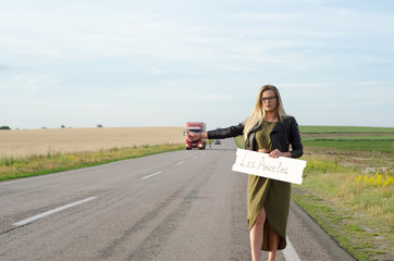 Portrait of a lady standing by the road.