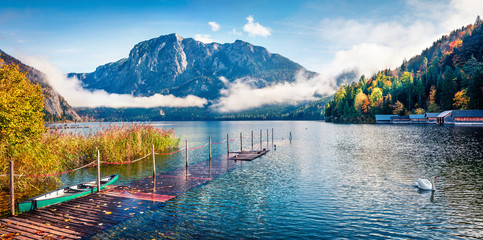 Foggy autumn scene of Altausseer See lake. Sunny morning panorama of Altaussee village, district of...