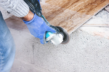the tiler cuts tiles professionally and efficiently with an angle grinder
