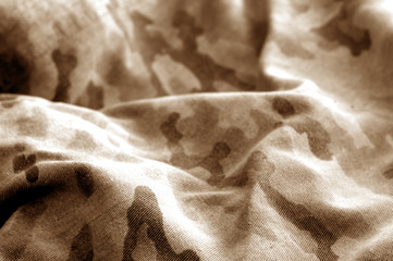 Old camouflage cloth with blur effect in brown tone.
