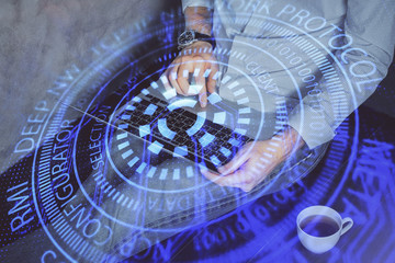 Multi exposure of data internet theme hologram with man working on computer on background. Concept of innovation.