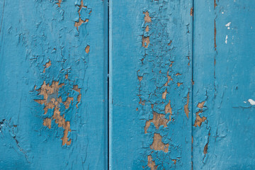 Blue wooden panels show signs of paint peeling.background.