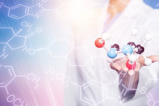 Close up of Molecular structure model in hand on background