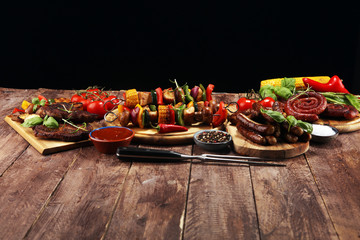 Assorted delicious grilled meat and skewer with vegetable on rustic table