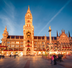 Fototapeta premium Impressive evening view of Marienplatz - City-center square & transport hub with towering St. Peter's church, two town halls and a toy museum, Munich, Bavaria, Germany, Europe.