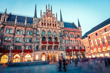 Fototapeta na wymiar Great evening view of Marienplatz - City-center square & transport hub with towering St. Peter's church, two town halls and a toy museum, Munich, Bavaria, Germany, Europe.
