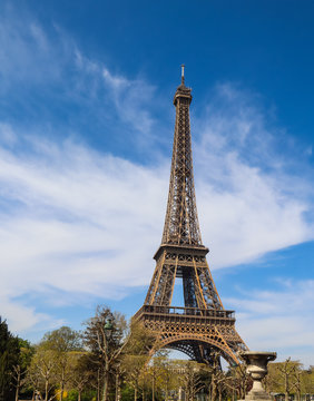 Eiffel Tower in Paris France against blue sky with clouds. April 2019