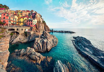 Second city of the Cique Terre sequence of hill cities - Manarola. Colorful spring morning in Liguria, Italy, Europe. Picturesqie seascape of Mediterranean sea. Traveling concept background. © Andrew Mayovskyy
