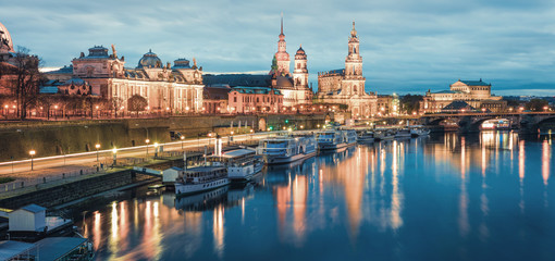 Great evennig panorama of Cathedral of the Holy Trinity or Hofkirche, Bruehl's Terrace or The Balcony of Europe. Beautiful autumn sunset on Elbe river in Dresden, Saxony, Germany, Europe.