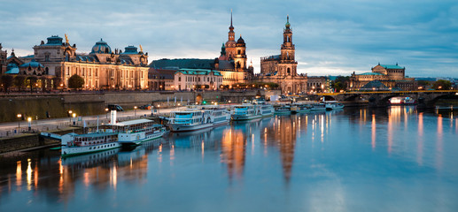 Fototapeta na wymiar Stunning evennig panorama of Cathedral of the Holy Trinity or Hofkirche, Bruehl's Terrace or The Balcony of Europe. Beautiful autumn sunset on Elbe river in Dresden, Saxony, Germany, Europe.