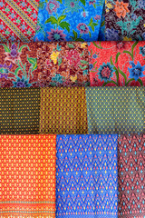 Colorful traditional sarongs for sale on street market in Thailand. Souvenirs for tourists at street market