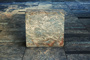 Cube object made of metamorphic rock in the city