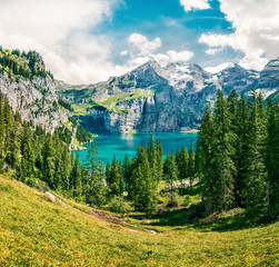 Picturesque summer view of unique Oeschinensee Lake. Sunny morning scene in the Swiss Alps with Bluemlisalp mountain, Kandersteg village location, Switzerland, Europe.