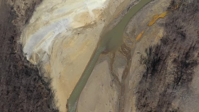Mine drainage pyrite on polluted river coast 4K drone video