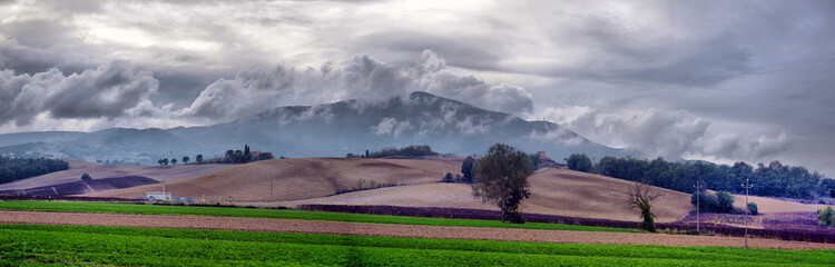 Fototapeta premium typical Tuscany countryside landscape; sunset over rolling hills