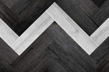 Wood texture for background. Black-white parquet floor with herringbone pattern. Panel of planks...
