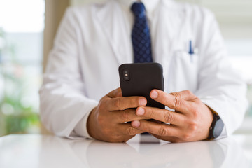 Close up middle age doctor man hands using smartphone