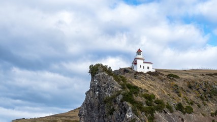 Fototapeta na wymiar lighthouse on the top of coastal rock