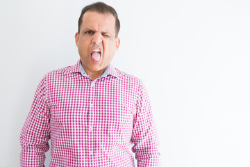 Obraz premium Middle age man wearing business shirt over white wall sticking tongue out happy with funny expression. Emotion concept.