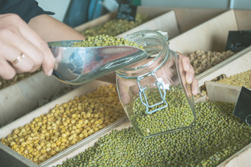 woman is bying products in zero waste shop