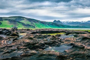Typical Icelandic landscape on the south coast of Iceland. Dramatic summer morning with volcanic...