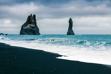 Splendid seascape of Reynisdrangar cliffs in the Atlantic ocean. Colorful summer morning in south Iceland, Vic village location, Europe. Instagram filter toned. Beauty of nature concept background.