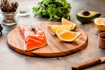 Salmon. Raw Trout Red Fish Steak served with Herbs, avocado and Lemonon. Wild north fish. Healthy eating concept.