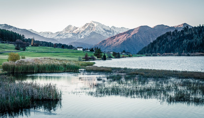 Spectacular autumn scene of Haidersee (Lago della Muta) lake with Ortler peak on background. Splendid morning view of Italian Alps, Italy, Europe. Instagram filter toned.