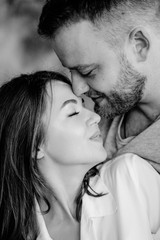 Couple in love in the bedroom. Slender brunette. Stylish interior.