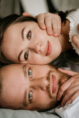 Couple in love in the bedroom. Slender brunette. Stylish interior.