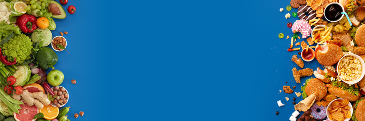 Fast food dish and health food on blue background. Take away unhealthy set including burgers, sauces, french fries. Comparison with healthy nutrition, vegetables and fruits. Flyer for your ad.