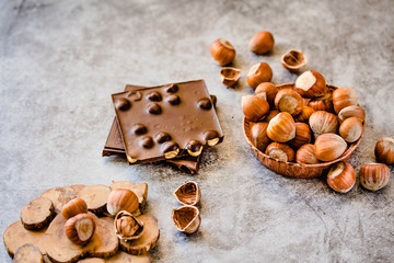Homemade hazelnut chocolate bar. Nuts and chocolate background. Ingredients for cooking homemade chocolate sweets. Confectionery and sweets concept