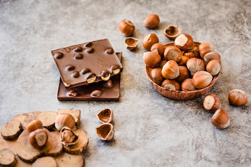 Fototapeta na wymiar Homemade hazelnut chocolate bar. Nuts and chocolate background. Ingredients for cooking homemade chocolate sweets. Confectionery and sweets concept