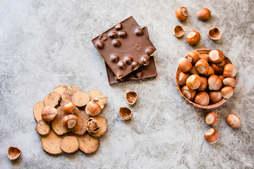 Hazelnut chocolate bar. Nuts and chocolate background. Ingredients for cooking homemade chocolate sweets. Confectionery and sweets concept