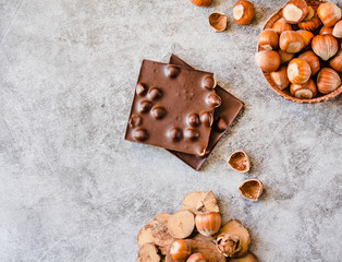 Homemade hazelnut chocolate bar. Nuts and chocolate background. Ingredients for cooking homemade chocolate sweets. Confectionery and sweets concept.Top view.