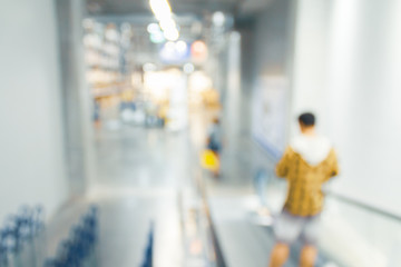 Blurred bix box store supercenter with customers shopping for home goods.