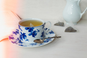 delicate cup of blue flowers porcelain . Sachets or teabag