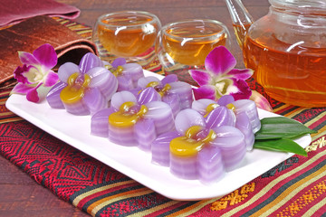 Fototapeta na wymiar Layer sweet cake (or Khanom Chan) Thai traditional dessert in colorful orchid flowers shaped. One of most famous Thai auspicious desserts in Thailand. Steamed layer cake, or layer sweetmeat.