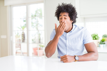 African American business man bored yawning tired covering mouth with hand. Restless and sleepiness.