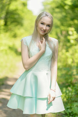 Fototapeta na wymiar Summertime portrait of young woman in dress.