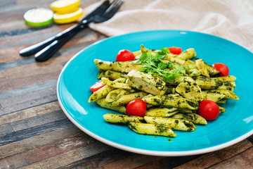 close-up of plate of pasta and chicken with lettuce