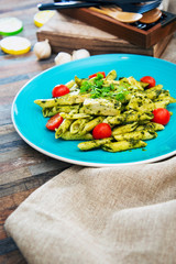 close-up of plate of pasta and chicken with lettuce