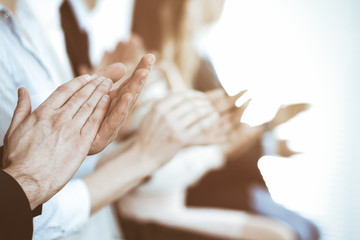 Business people clapping and applause at meeting or conference, close-up of hands. Group of unknown...