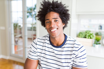 Fototapeta premium African American man wearing stripes t-shirt with a happy and cool smile on face. Lucky person.