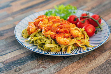 Small Gambas, stewed tomatoes, Tagliatelle with pesto