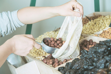 woman is bying products in zero waste shop