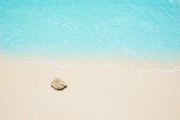 Soft waves of blue sea on the Maldives beach for the background.