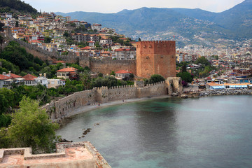Fototapeta na wymiar Tower and fortress wall of an ancient coastal fortress in Alanya, Turkey